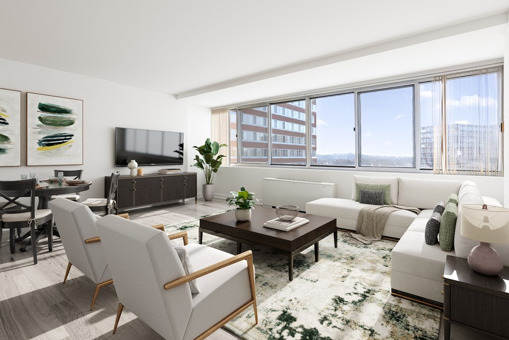 a living room with white furniture and a large window