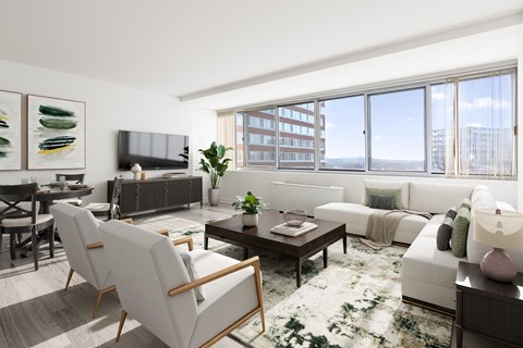 a living room with white furniture and a large window