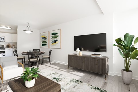 a living room with a large tv and a table and chairs