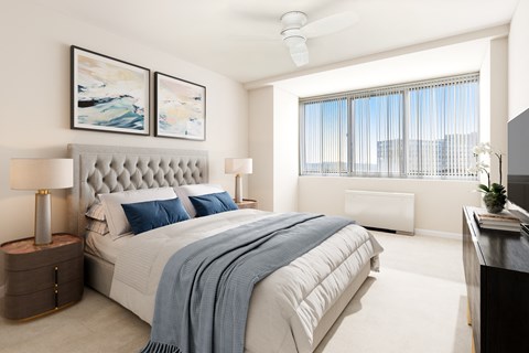 a bedroom with a bed and a large window