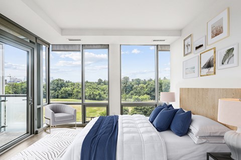 a bedroom with a bed and a view of a large window