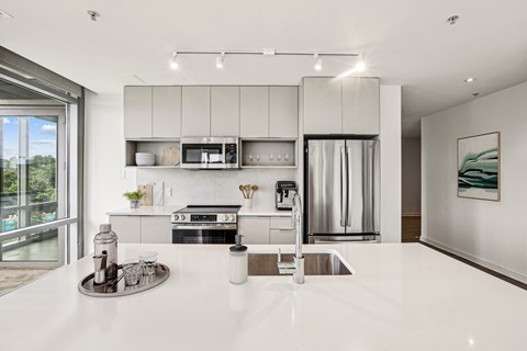 a kitchen with white counter tops and a sink