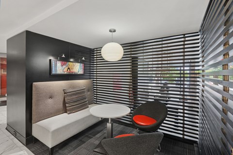 A modern living room with a sofa, chair, and a table.