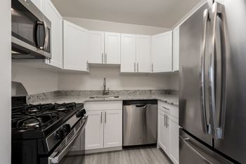 Shaker white cabinetry and quartz countertops available in select premium units
