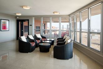 a seating area in a room with large windows