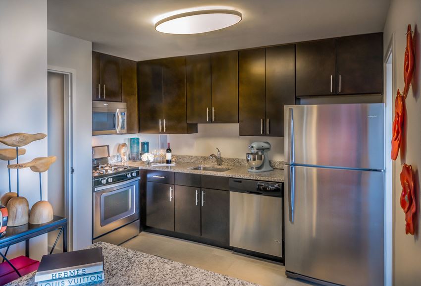Kitchen with fridge, microwave, stove, oven, and sink