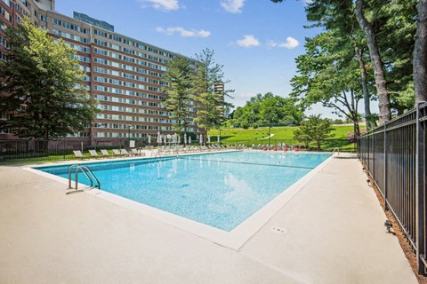 a large swimming pool in front of a building