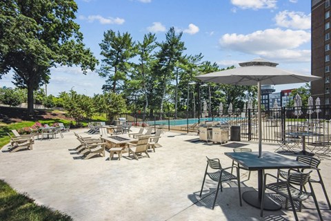 a patio with tables and chairs and a swimming pool
