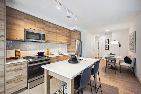 a kitchen and dining area with a table and chairs and a stove and microwave
