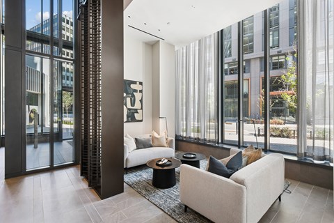A modern living room with a large window and a white couch.
