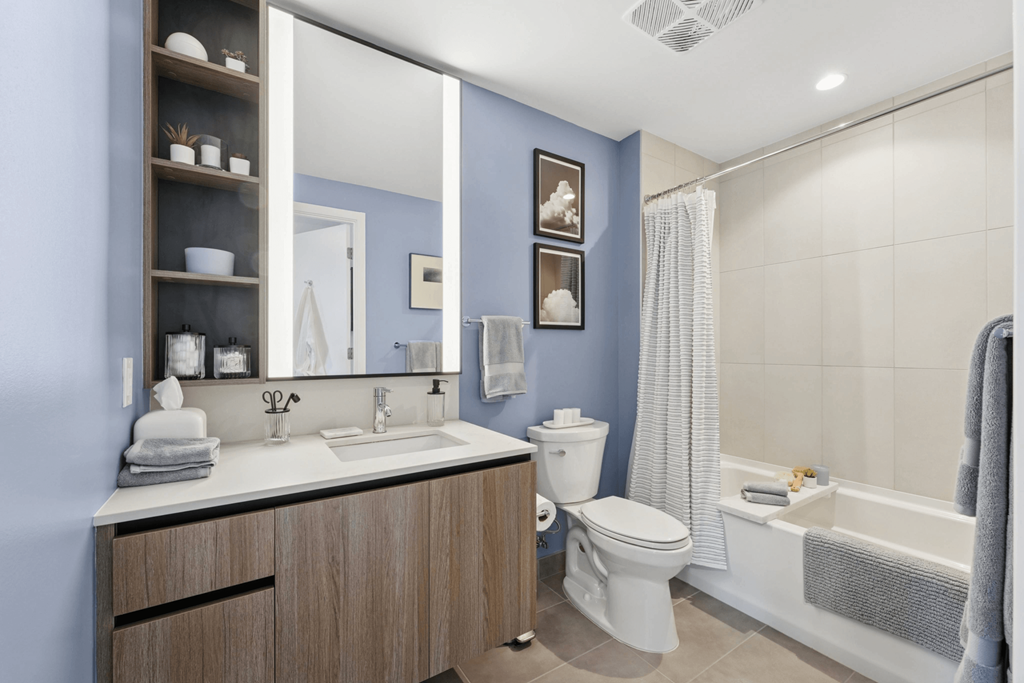 A bathroom with blue walls and a white sink.