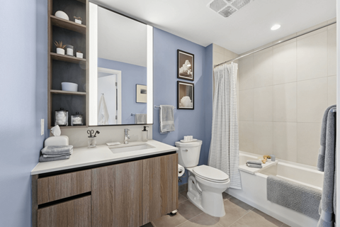 A bathroom with blue walls and a white sink.