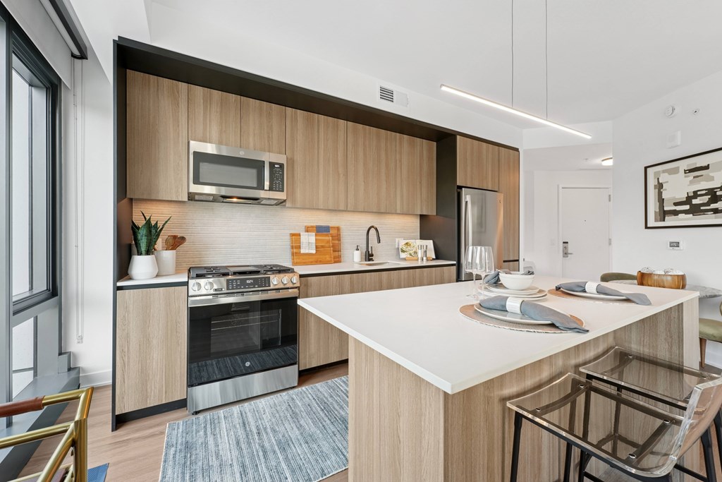 A modern kitchen with a wooden cabinet and stainless steel appliances.