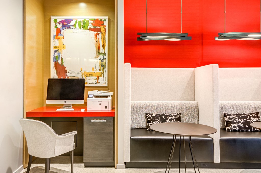 a living room with a table and chair and a television