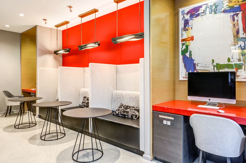 a room with tables and chairs and a television