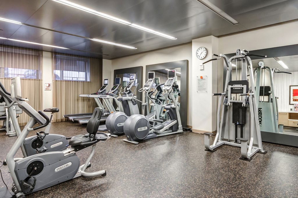 a gym with cardio equipment and weights in a building