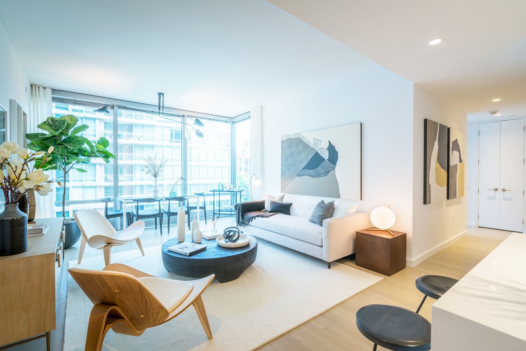 a living room with a couch and a coffee table in front of a window