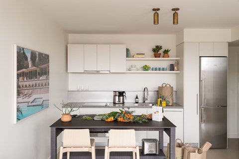A modern kitchen with a dining table and chairs.