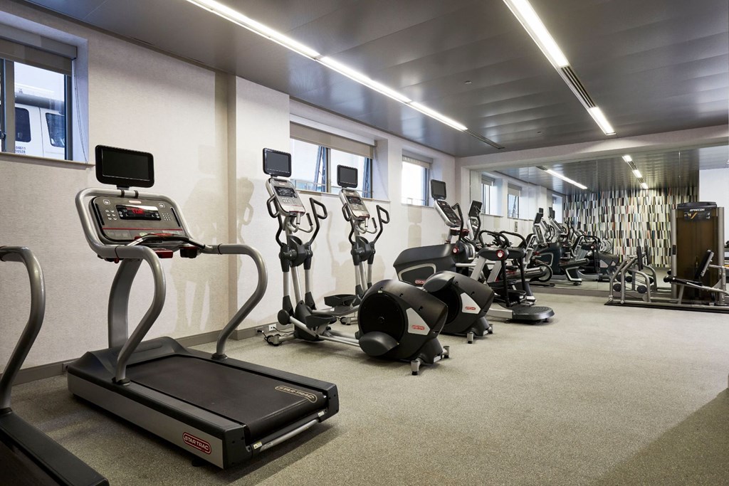 a gym with various exercise bikes and weights