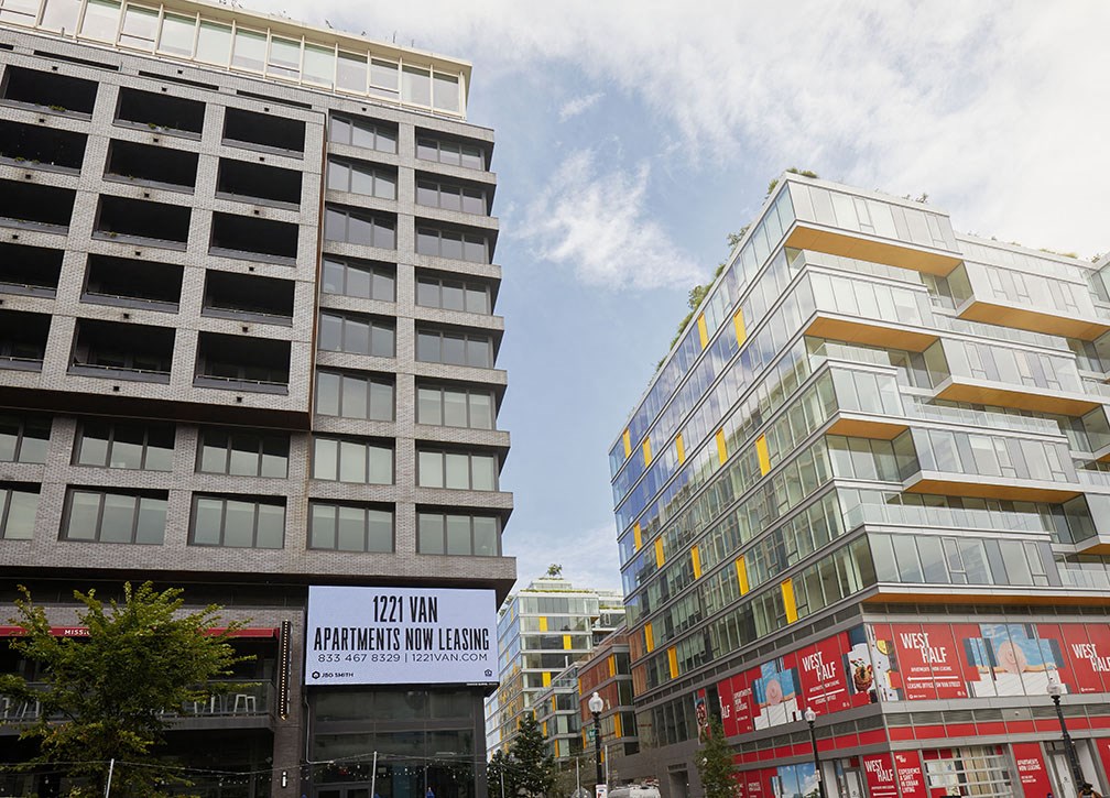 two tall buildings on a city street next to each other