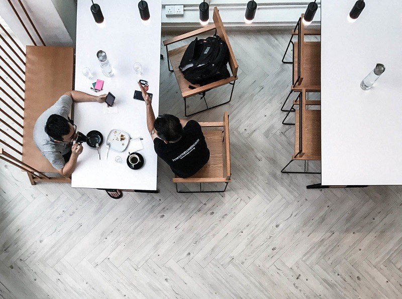 two people sitting at a table in a restaurant