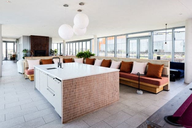 a large living room with a kitchen and a couch