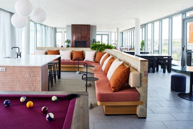 a living room with a pool table and a bar