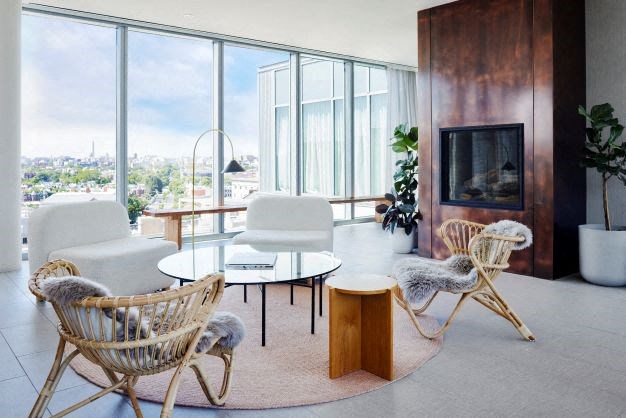 a living room with a television and chairs and a table