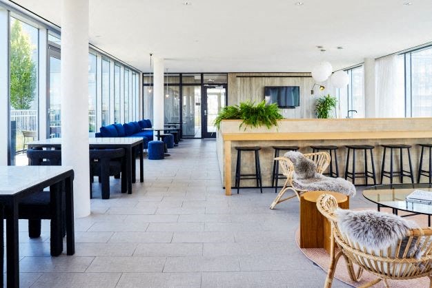 a large room with tables and chairs and a bar