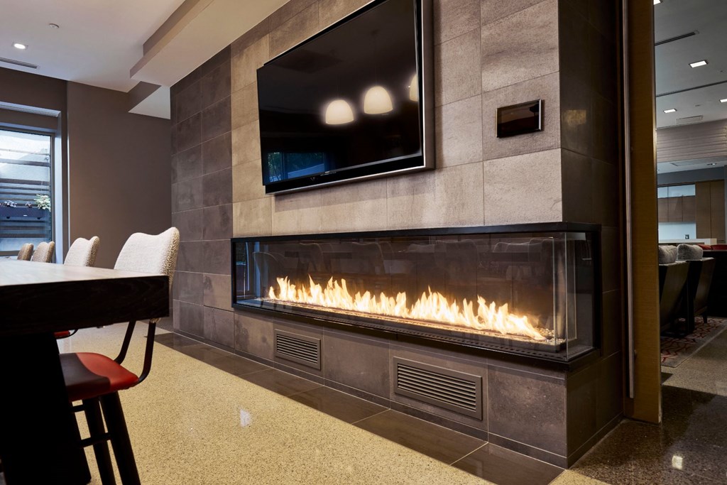 a living room with a fireplace and a tv