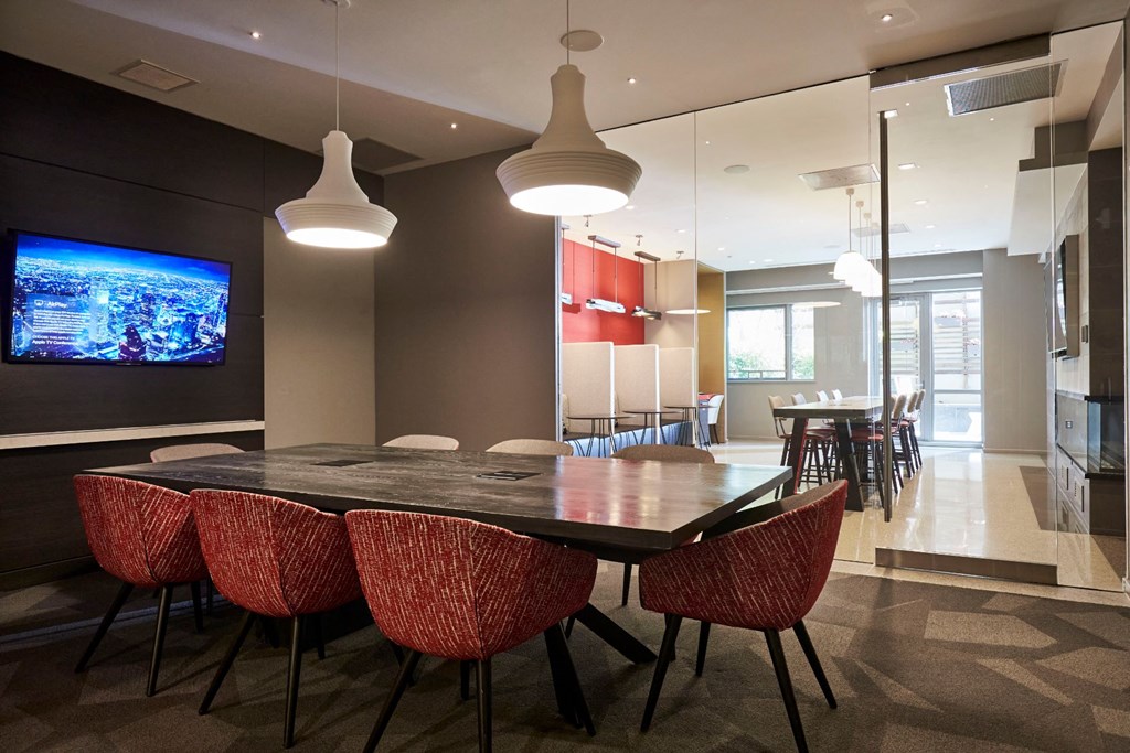 a dining room with a table and chairs and a television