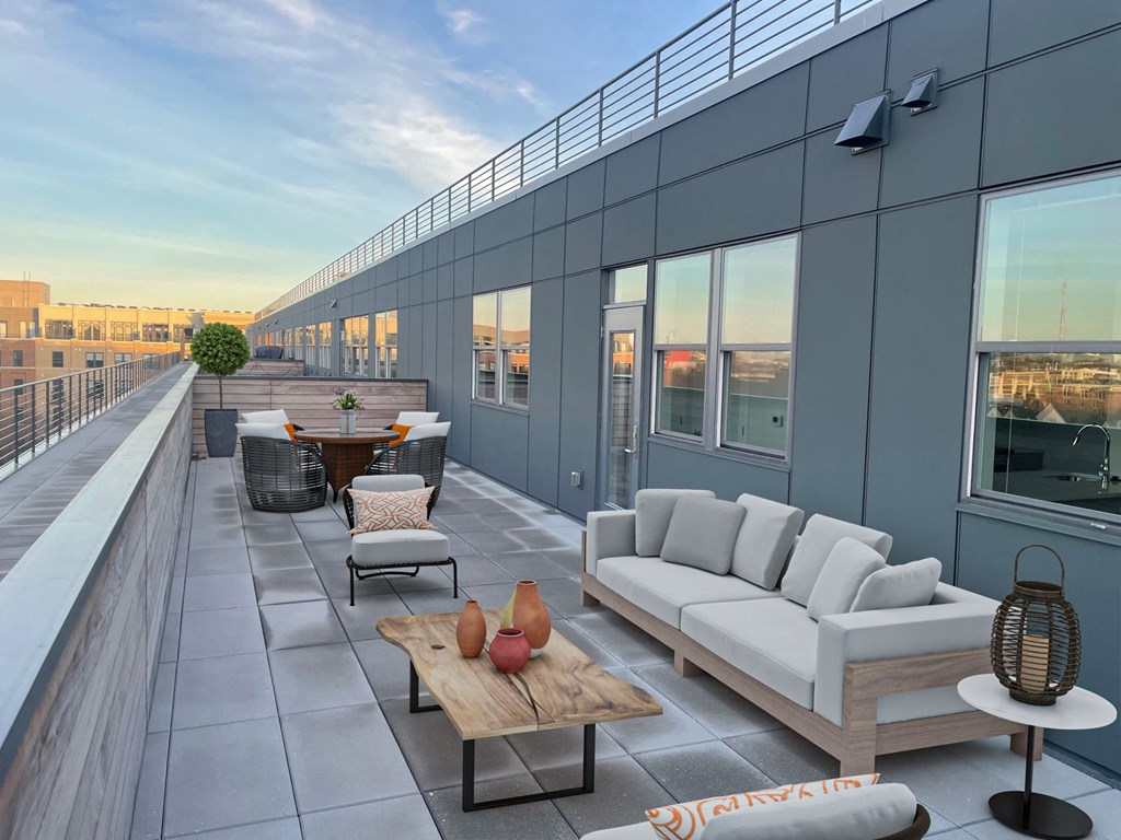 a terrace with couches and tables on a roof top