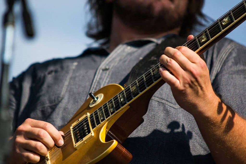 a man playing a guitar with his hands