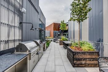 Resident-only lounge with grilling stations and outdoor terrace
