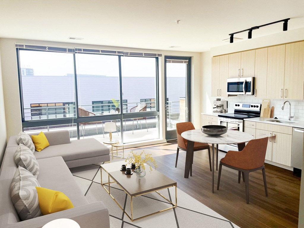 a living room with a couch and a table and a balcony