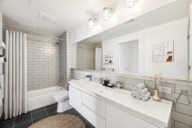 a bathroom with a sink and a toilet and a bath tub