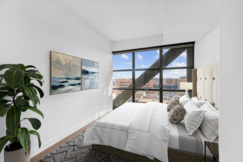 a bedroom with a large bed and a window