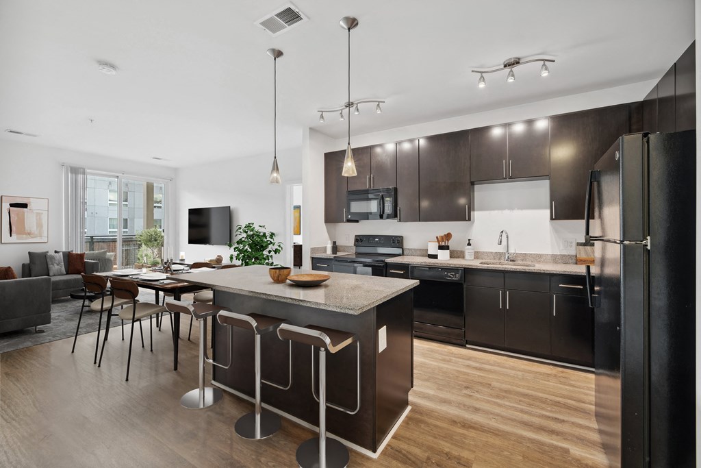 a kitchen with a large island and a table with chairs