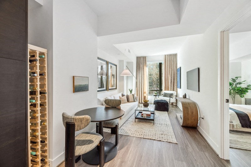 a living room with a couch and a table  and a bedroom