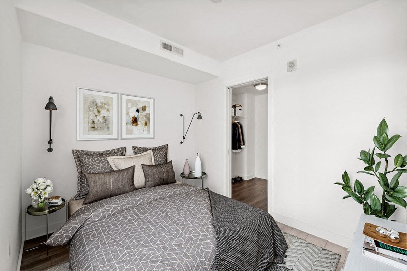 a bedroom with a bed and two pictures on the wall