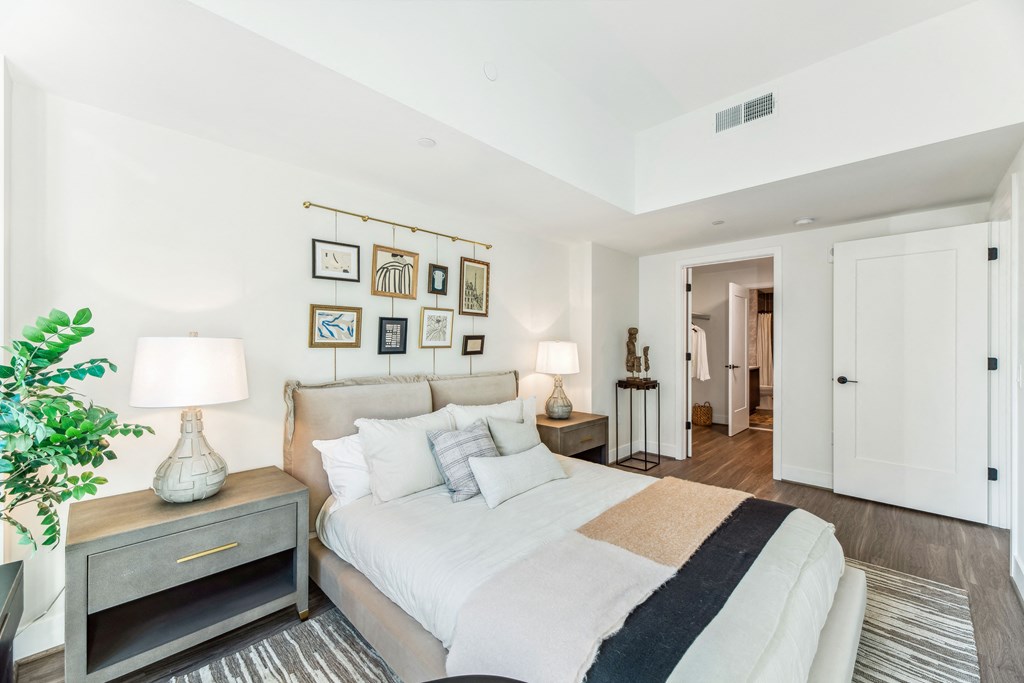 a bedroom with a large bed and a large window