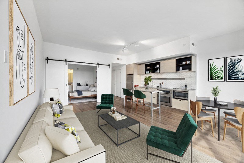 the living room and kitchen of a modern apartment