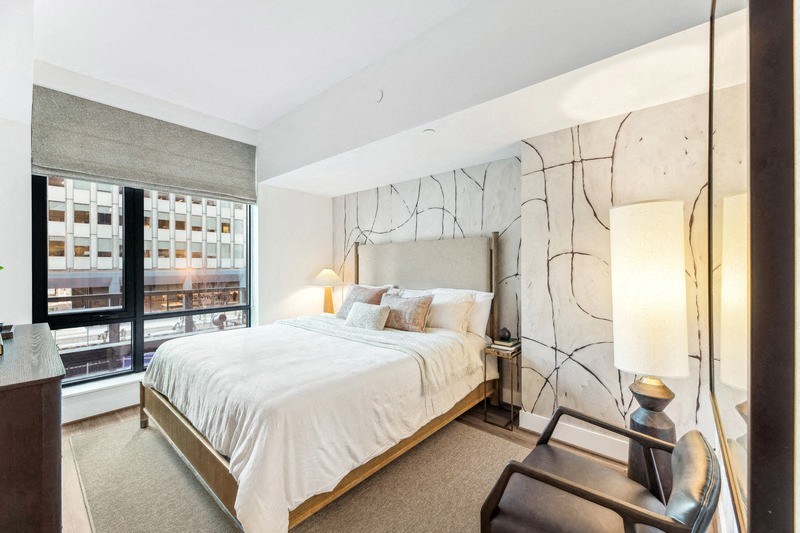 a bedroom with a large bed and a large window