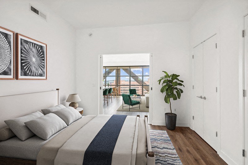 a bedroom with a bed and a door to a balcony