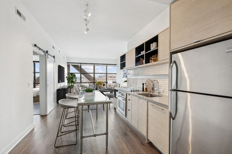 a kitchen with stainless steel appliances and a small table