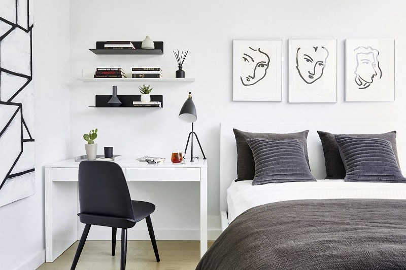 a bedroom with a bed and a desk with a chair