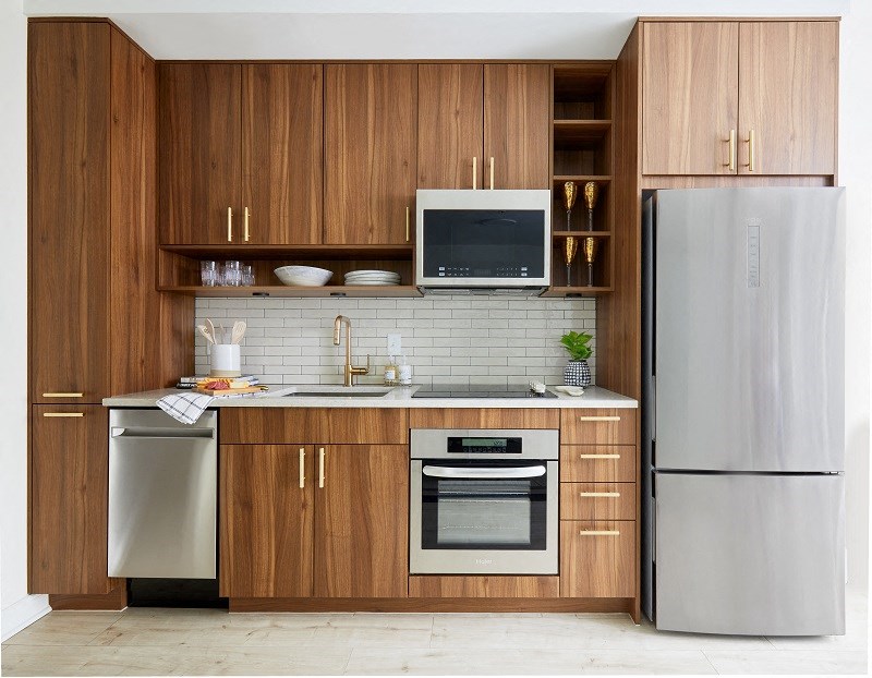 a kitchen with wooden cabinets and a stainless steel refrigerator