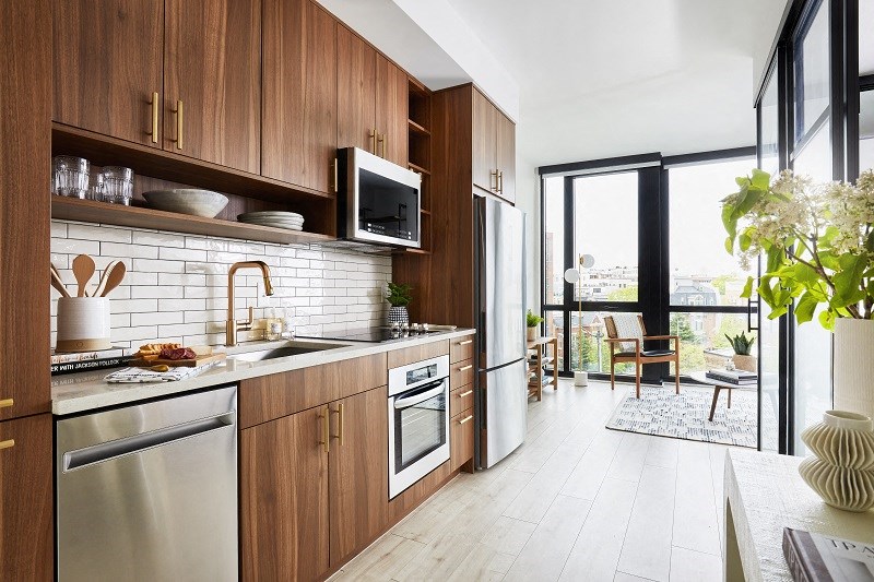 a kitchen with wooden cabinets and a sink and a window