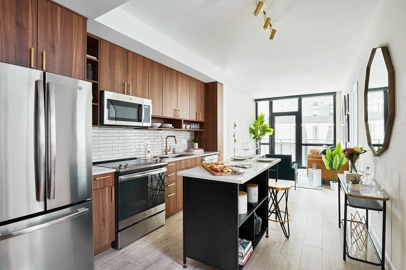a kitchen with stainless steel appliances and wooden cabinets