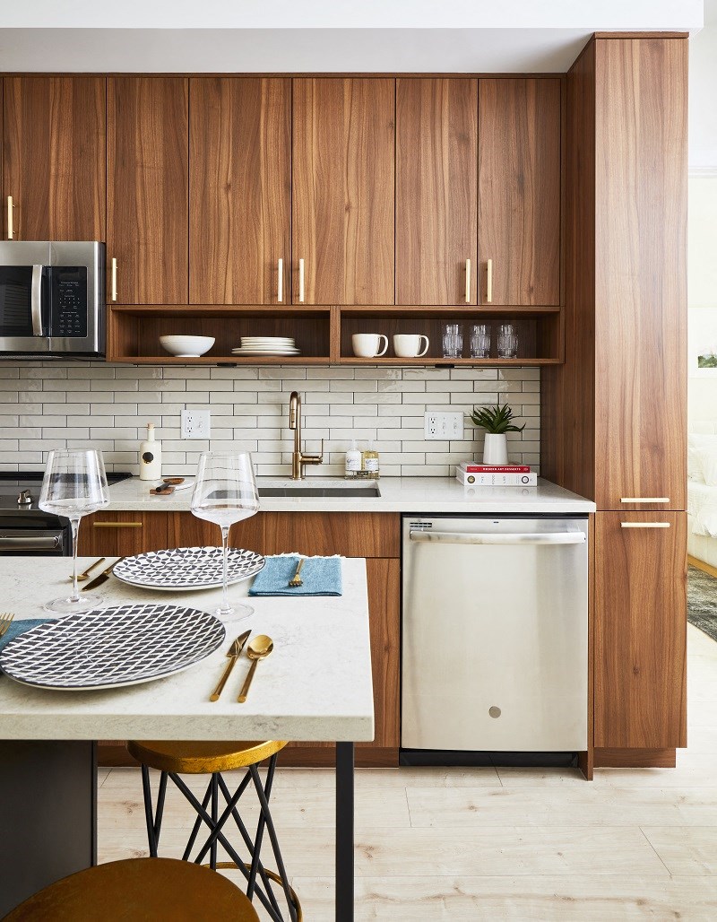 a kitchen with wooden cabinets and a white counter top